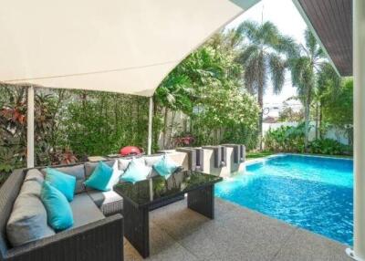 Outdoor patio with seating area and swimming pool