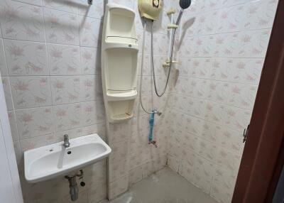 Bathroom with shower, sink, and water heater