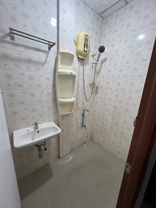 Bathroom with shower, sink, and water heater