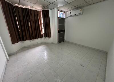 Empty room with tiled floor and air conditioner