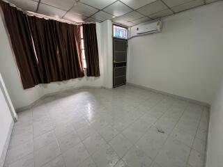 Empty room with tiled floor and air conditioner