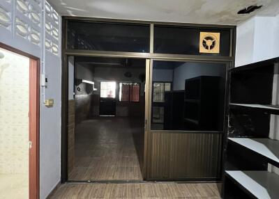 Empty room with wooden flooring and glass door