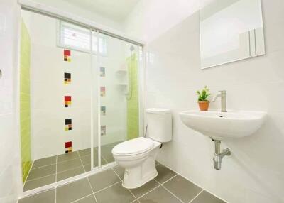 Modern bathroom with glass shower enclosure and tiled floor