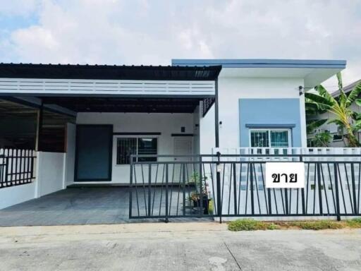 Exterior view of a modern single-story house with a carport