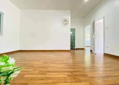 Spacious empty room with wooden flooring