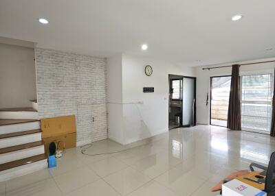 spacious living room with tiled floors and ample natural lighting