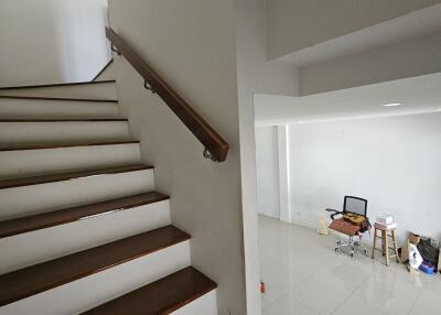 Staircase leading to a room with some unpacked items