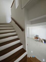 Staircase leading to a room with some unpacked items