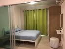 Modern bedroom with glass sliding doors and green curtains