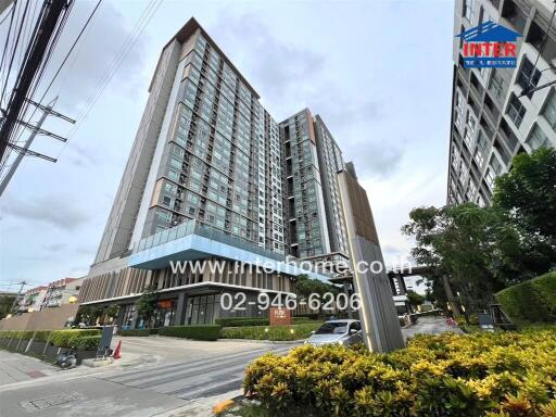 Modern high-rise residential building exterior with landscaped surroundings