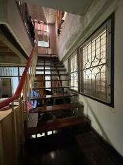 Indoor staircase with metal railings and large window