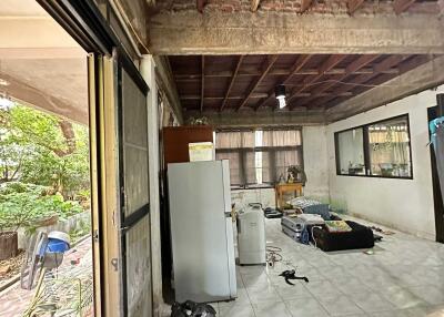 Under-construction or renovation space with exposed beams and tiled floor