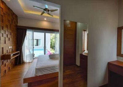 Bedroom with pool view and modern decor
