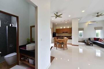 Open layout of a living space with a kitchen and dining area visible, as well as a bathroom