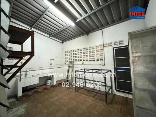 Utility room with tiled flooring and shelving