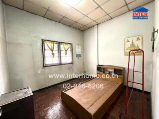 Bedroom with basic furniture and natural light