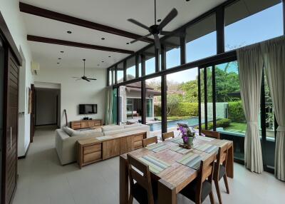 Spacious living and dining area with pool view