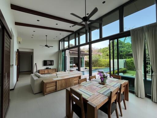 Spacious living and dining area with pool view