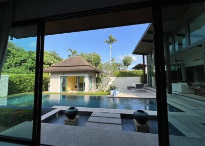 View of a modern villa with swimming pool and garden
