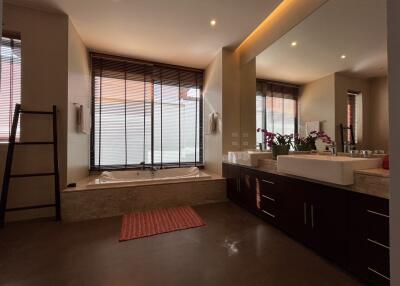 Modern bathroom with bathtub and large mirror