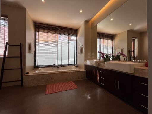 Modern bathroom with bathtub and large mirror