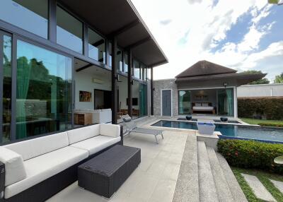 Spacious outdoor living area featuring a pool, seating, and modern architecture