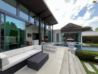 Spacious outdoor living area featuring a pool, seating, and modern architecture