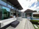 Spacious outdoor living area featuring a pool, seating, and modern architecture