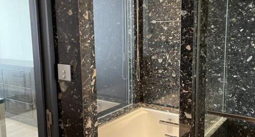 Modern bathroom with black marble tiles