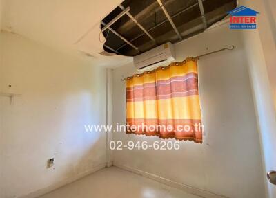 Small bedroom with damaged ceiling