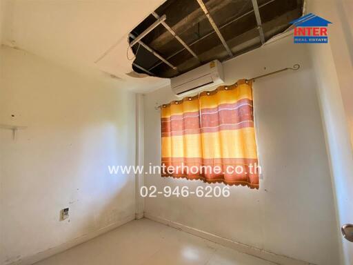 Small bedroom with damaged ceiling