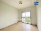 Empty bedroom with large window and tiled floor