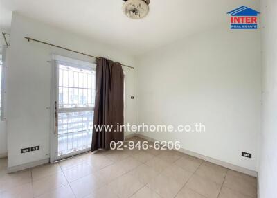 Empty room with tiled flooring and a window with a curtain