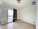 Empty room with tiled flooring and a window with a curtain