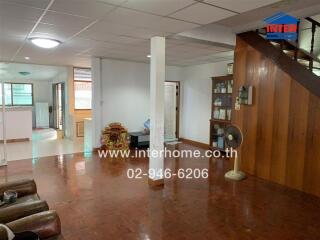 Spacious living area with wooden flooring and staircase