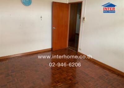 Empty room with wooden floor and door