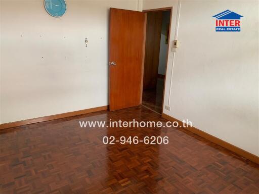 Empty room with wooden floor and door