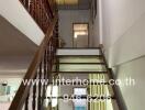 Staircase with wooden handrails leading to the upper floor