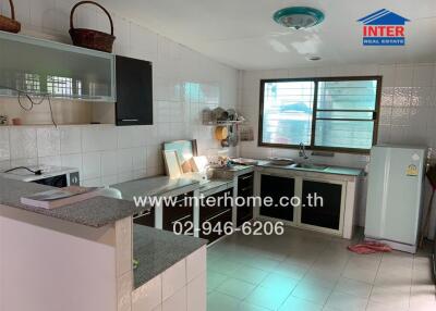 Modern kitchen with essential appliances and ample storage space
