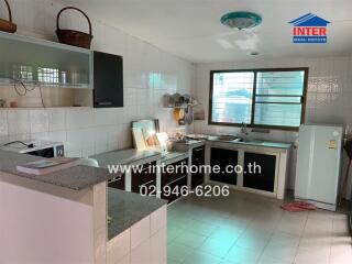 Modern kitchen with essential appliances and ample storage space