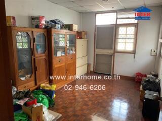 Room with wooden cabinets and miscellaneous items