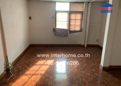 Empty room with parquet flooring and window