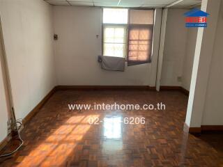 Empty room with parquet flooring and window