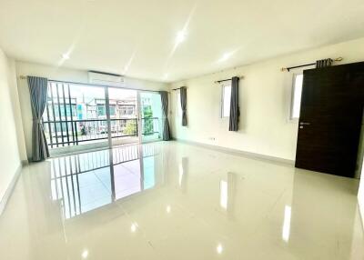 Spacious and bright living room with large windows and tiled floor