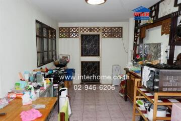 A cluttered kitchen space with various appliances and items.