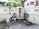 Outdoor utility area with a large water tank