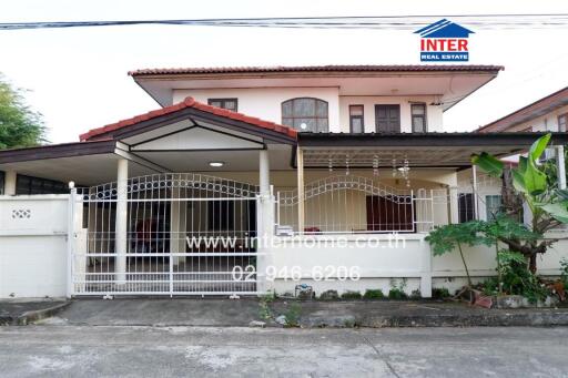 Front view of a two-story residential house with gated entrance