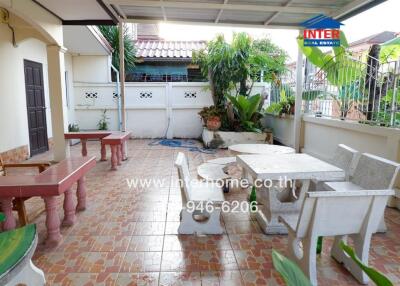 Outdoor patio area with tiled floor and seating