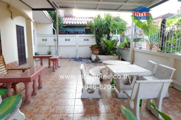 Outdoor patio area with tiled floor and seating