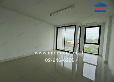 Empty room with large windows and reflective floor